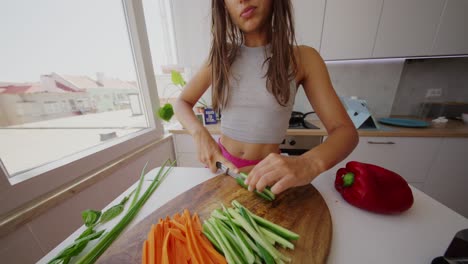woman chopping vegetables in a kitchen