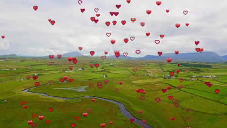 Hearts-animation-over-green-landscape-with-river-and-mountains-in-background