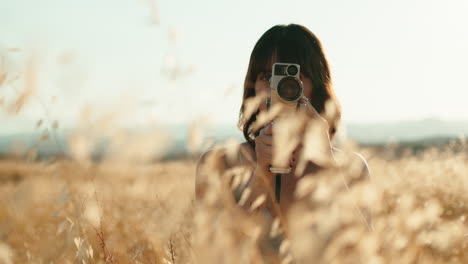 woman with vintage camera in countryside