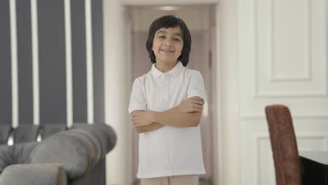 Happy-Indian-boy-standing-crossed-hands