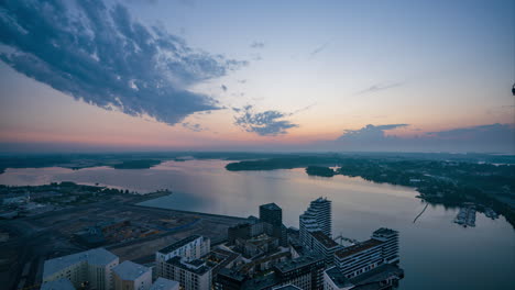 time lapse of a serene, summer sunrise above the sea and east helsinki, finland