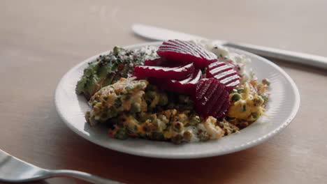 healthy high protein lunch with beetroot, peas, scambled eggs, avocado and grained cream cheese