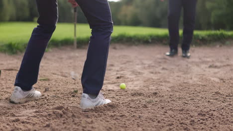 playing golf near a sand pit
