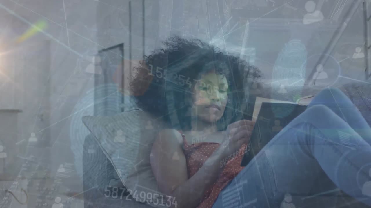 Animation of data processing over african american woman reading book