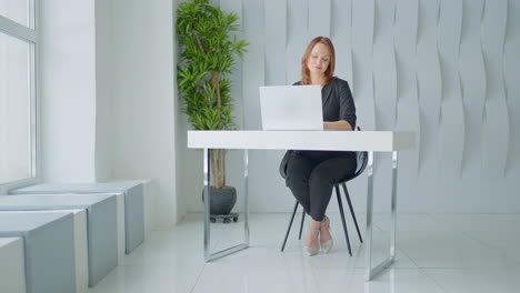 woman working on laptop in a modern office