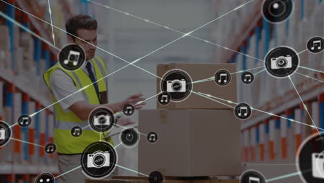 network of digital icon against caucasian male supervisor with clipboard checking stock at warehouse