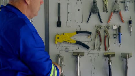 male engineer removing various tools in the hangar 4k