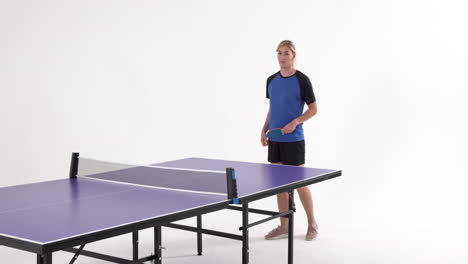 female table tennis player serving and passing the ball on white background, copy space