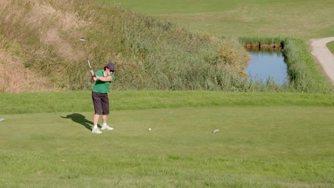 casual woman golf player shooting a drive shot