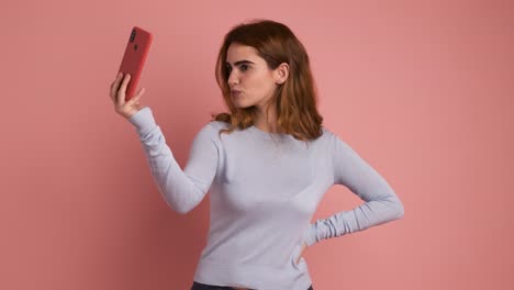 woman posing and smiling while taking a selfie