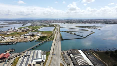 aerial view of a highway road surrounded by river channels factories