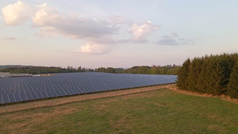 low aerial flyover a large solar panel field creating clean renewable energy