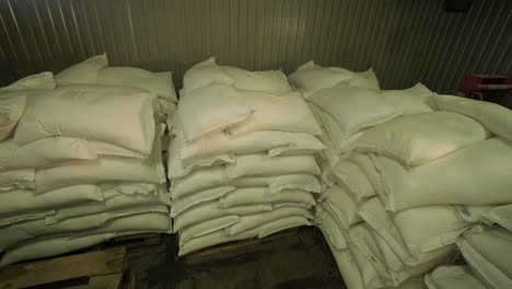 stacked bags of material in a warehouse