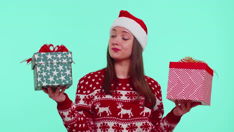 Woman-in-Christmas-red-sweater-Santa-hat,-smiling,-holding-two-gift-boxes-New-Year-presents-shopping