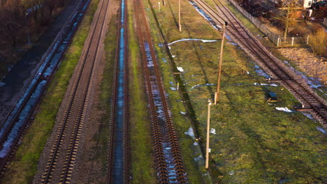 Empty railway tracks in aerial view on sunny spring day