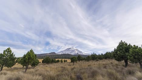 Time lapse of Popocatepetl active volcano with eruption and fumarole ashes during golden hour before sunset. Mexico
