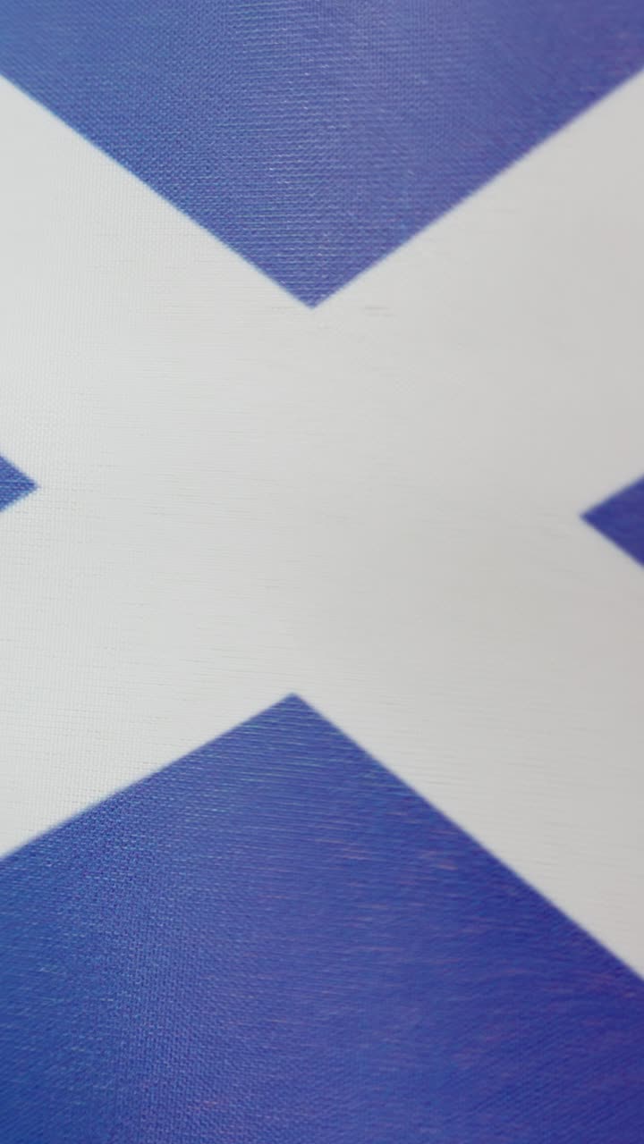 Vertical video of scottish national flag waving by the wind