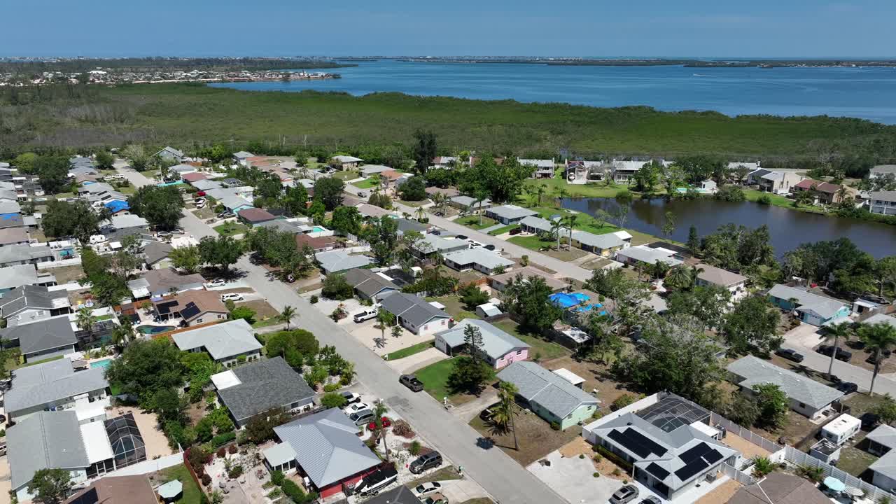 Aerial view of Cortez, Florida, showing coastal community. Quaint homes are nestled among lush greenery, with beautiful waterways in background. Suburb district with greenery and seascape.