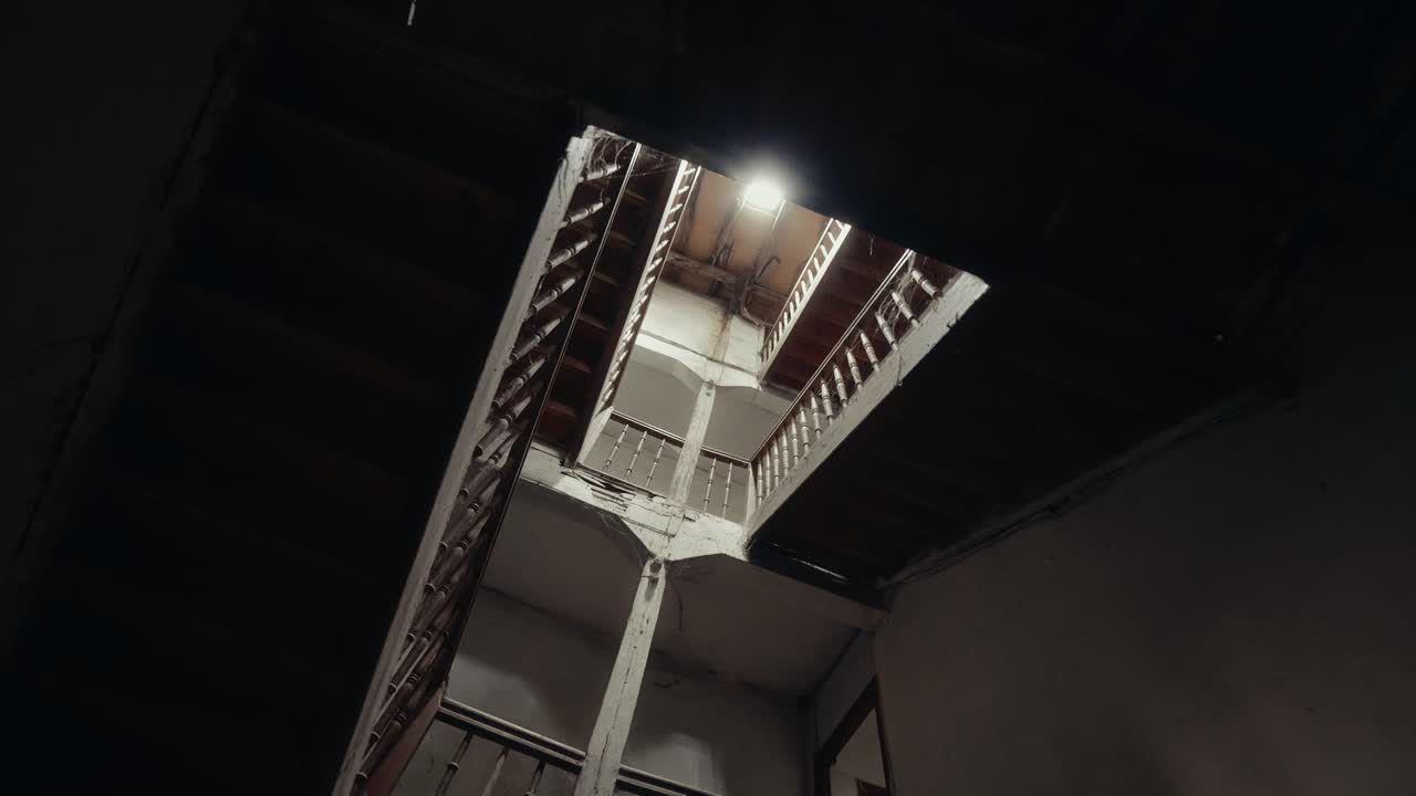 Low Angle View of a Dark Abandoned Building Stairwell