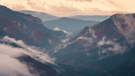 close up detail shot of roncal valley in spain pyrenees during misty low clouds and high clouds cloudy sunrise beautiful valley during fall autumn season timelapse