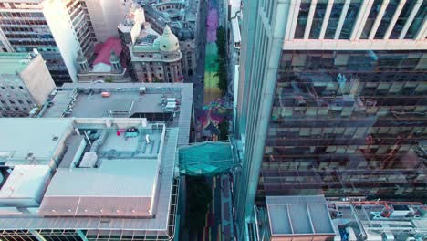 aerial establishing shot of the bright artwork on display at paseo bandera and a glass bridge connecting two buildings