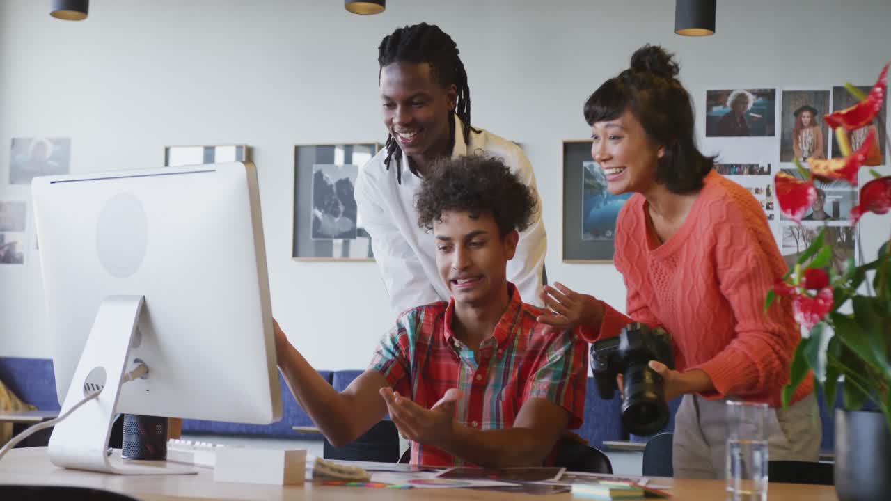 Happy diverse business people discussing work during meeting at office