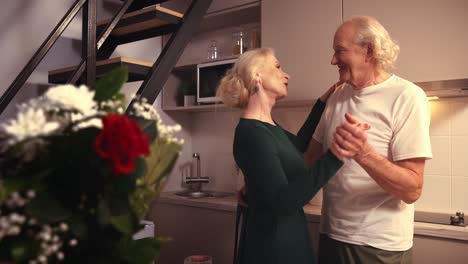 senior couple dancing in the kitchen