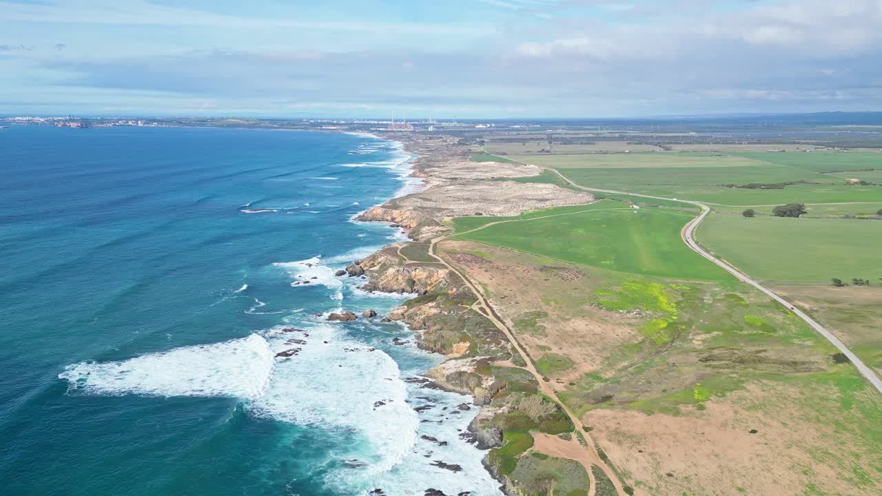 Coastal cliffs and ocean waves at Praia de Samoqueira, Alentejo, Portugal