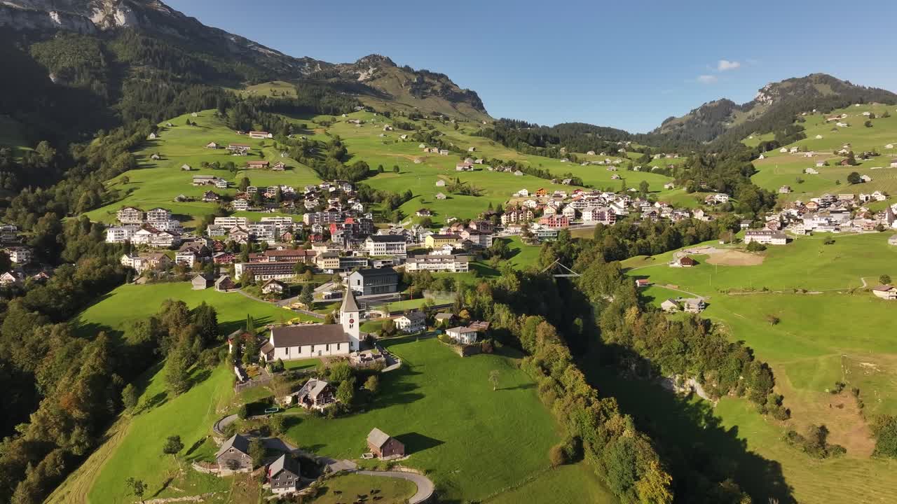 Breathtaking aerial image of a small village nestled in the heart of the Swiss Alps.
