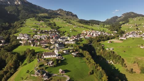 breathtaking aerial image of a small village nestled in the heart of the swiss alps.