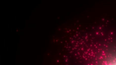 pequeñas partículas rojas y estrellas en fondo oscuro