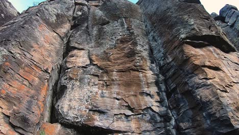 tilt-up from a cave entrance to the sheer rock wall above it