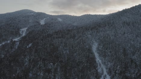 flying towards the snow dusted peak of a retired ski mountain aerial