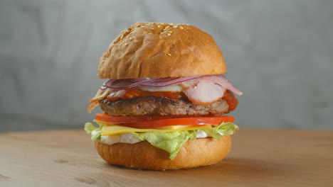 a delicious cheeseburger served on a wooden platter.