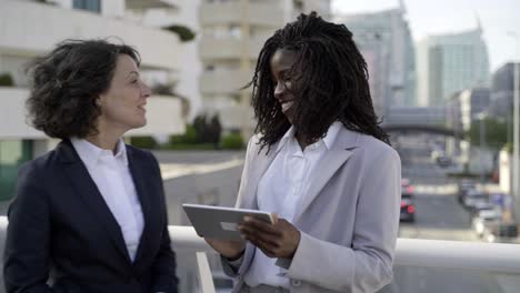 smiling businesswomen with tablet pc