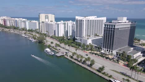 an epic aerial perspective along collins avenue as a drone captures the modern hotel buildings that line the ocean front and offers breathtaking views of the water