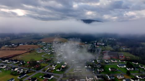 aerial drone footage within the clouds over a rural community