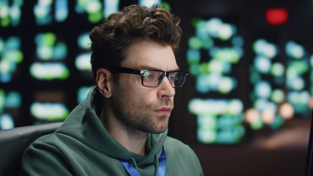 Technical controller working monitors in advanced monitoring office closeup