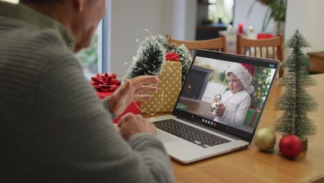 Caucasian-senior-man-on-video-call-with-grandson-at-christmas-time