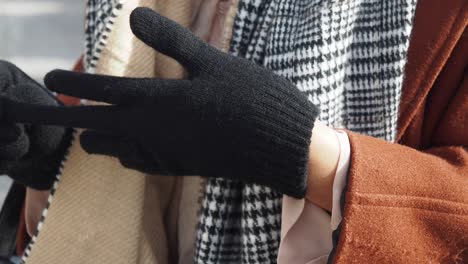 close up of a woman wearing black gloves