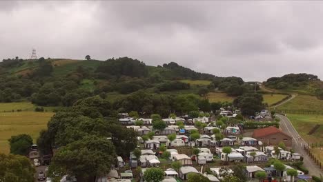 a camping site, playa de isla, with caravans and lush green landscape, aerial view