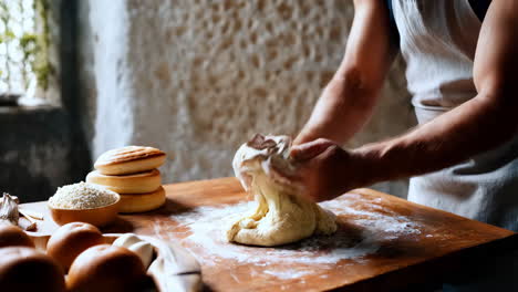 a baker kneading dough