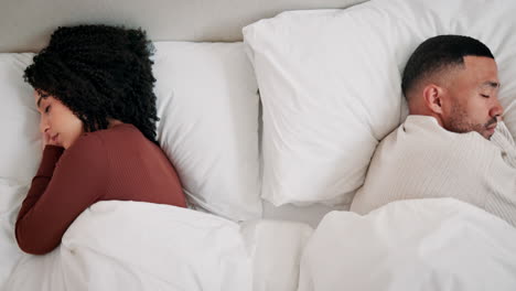 couple sleeping in separate beds