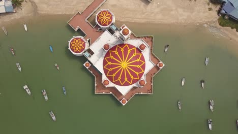 aerial ascending top down view floating mosque