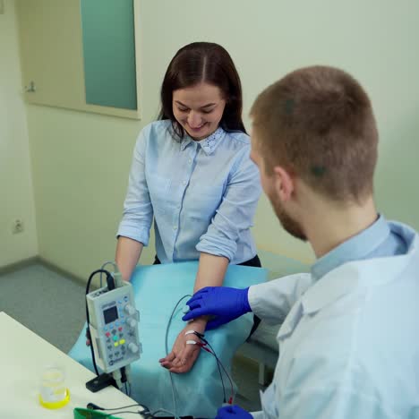 patient in examination room at hospital. rear view of doctor treating young woman