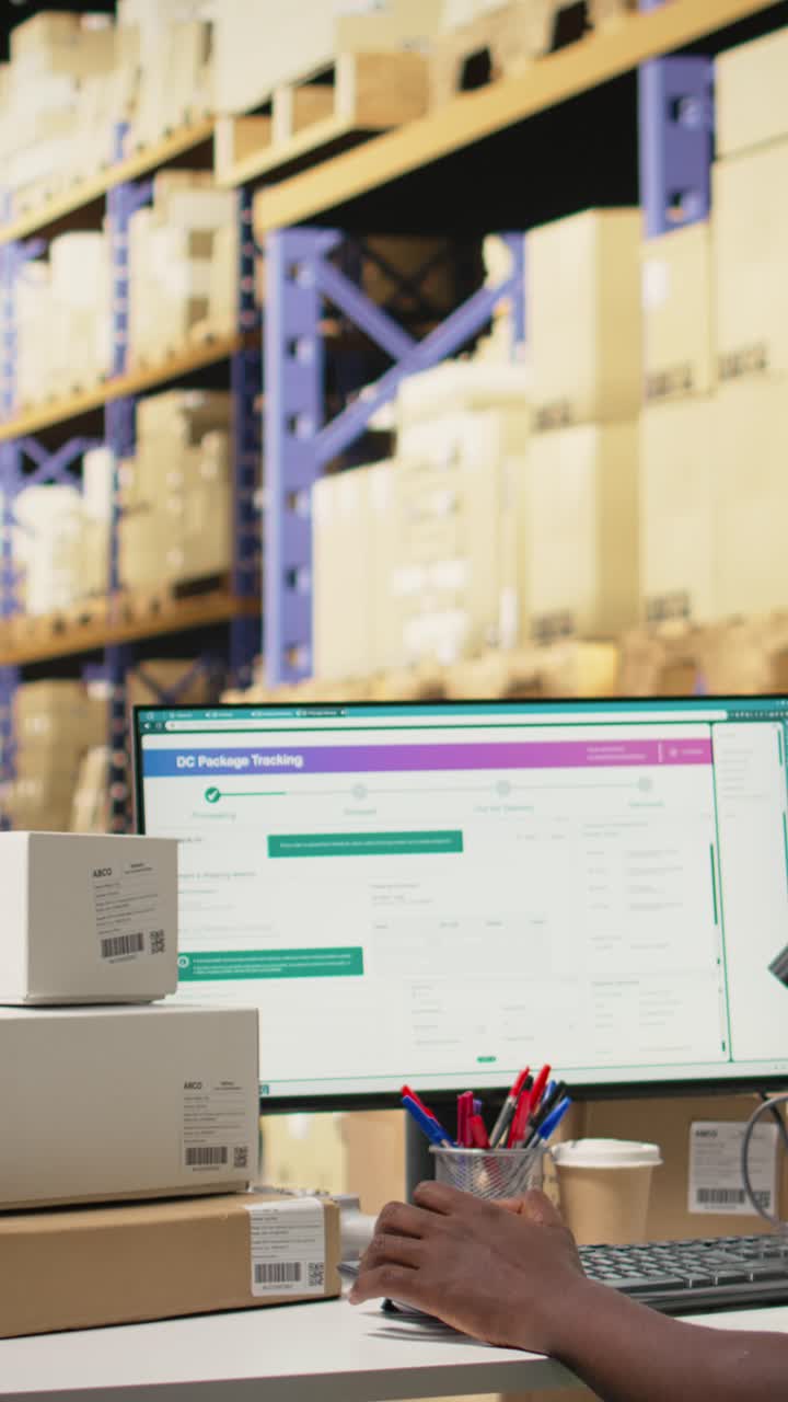 Vertical Video Young man using scanner on barcodes and applying tags in distribution hub