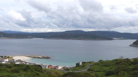 cabo ortegal high view and road to estaca de bares throuhg eucalyptus forest in galicia, car passing by on a cloudy day, up hill with sony rx100 va