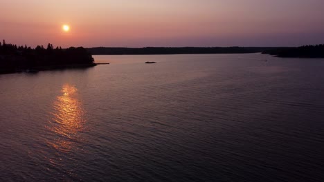 sunset over stockholm archipelago, serene waters with reflections, aerial view