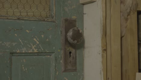 old creaky doorknob spins in doorframe