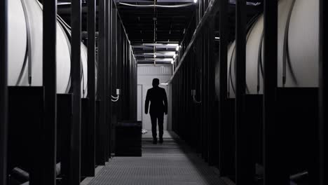 businessperson walking through an industrial corridor
